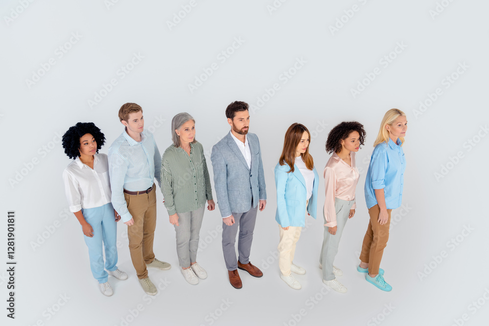 Group of diverse business professionals standing in unity against a gray background, symbolizing teamwork and collaboration, top view Group of diverse business professionals standing in unity against a gray background, symbolizing teamwork and collaboration, top view