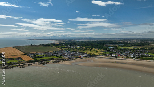 Photography Aerial panorama of Sutton in Dublin showcasing the golden harvest fields alongside the sandy Burrow Beach and the blue waters of Dublin Bay
