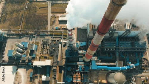 Coal power plant emits significant air pollution from tall smokestacks in industrial area