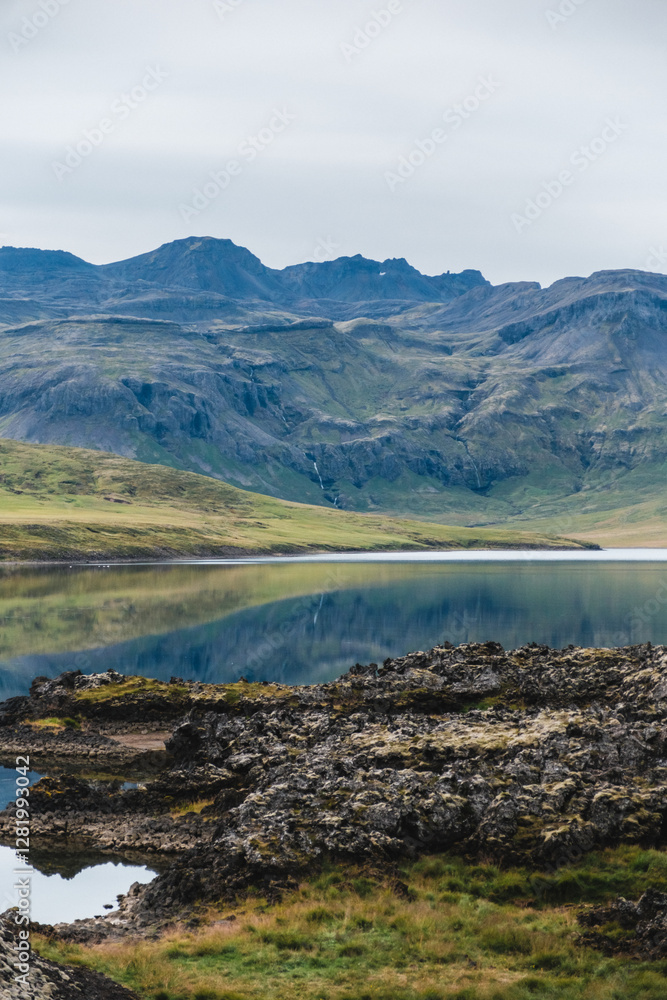 Fototapeta premium Scenic view of Lake Hraunsfjardavatn reflecting mountains in Berserkjahraun, Snæfellsnes Peninsula, West Iceland
