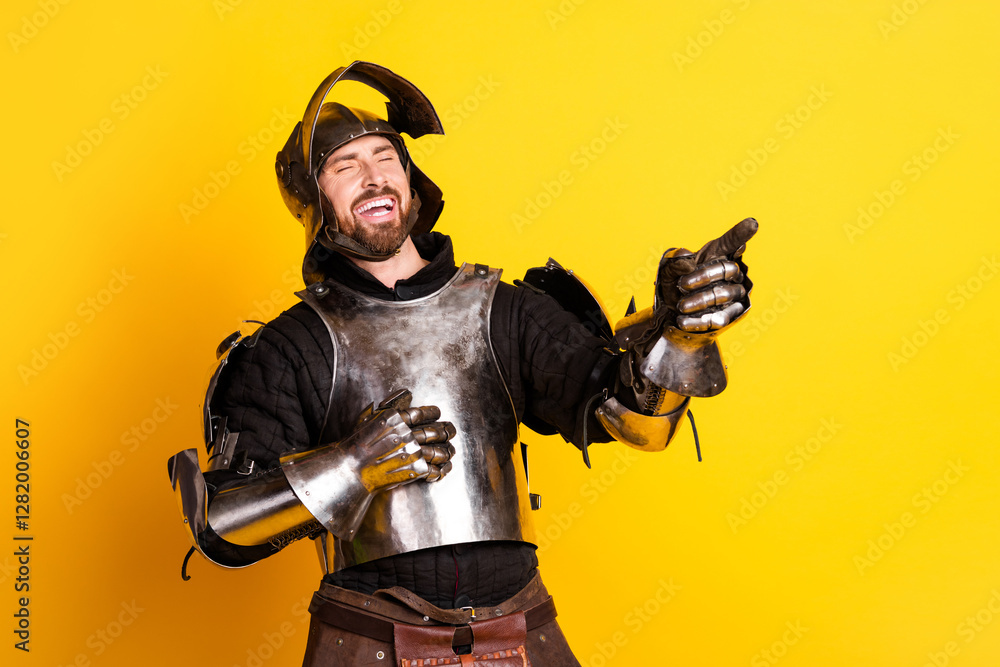 Fototapeta premium Young Man Dressed as a Medieval Knight Smiling on Bright Yellow Background