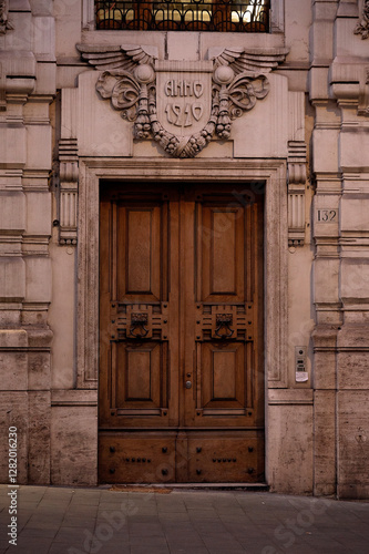 An ornate wooden door with intricate stone carvings in a historic building