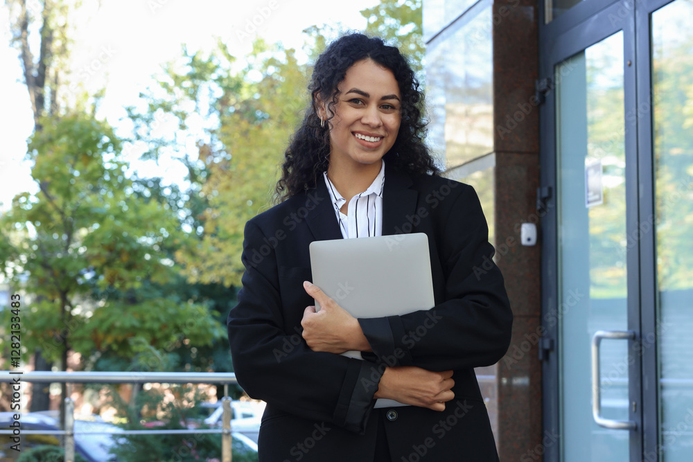 Portrait of young woman with laptop wearing stylish suit outdoors Portrait of young woman with laptop wearing stylish suit outdoors