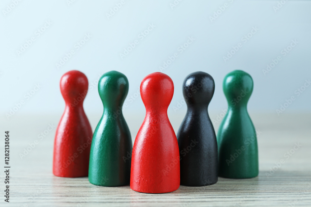 Human resources concept. Colorful figures on wooden table against light background, closeup Human resources concept. Colorful figures on wooden table against light background, closeup