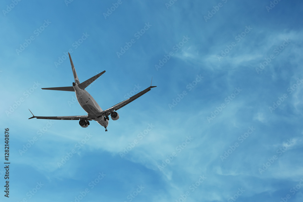 Airplane flying in beautiful blue sky with clouds Airplane flying in beautiful blue sky with clouds