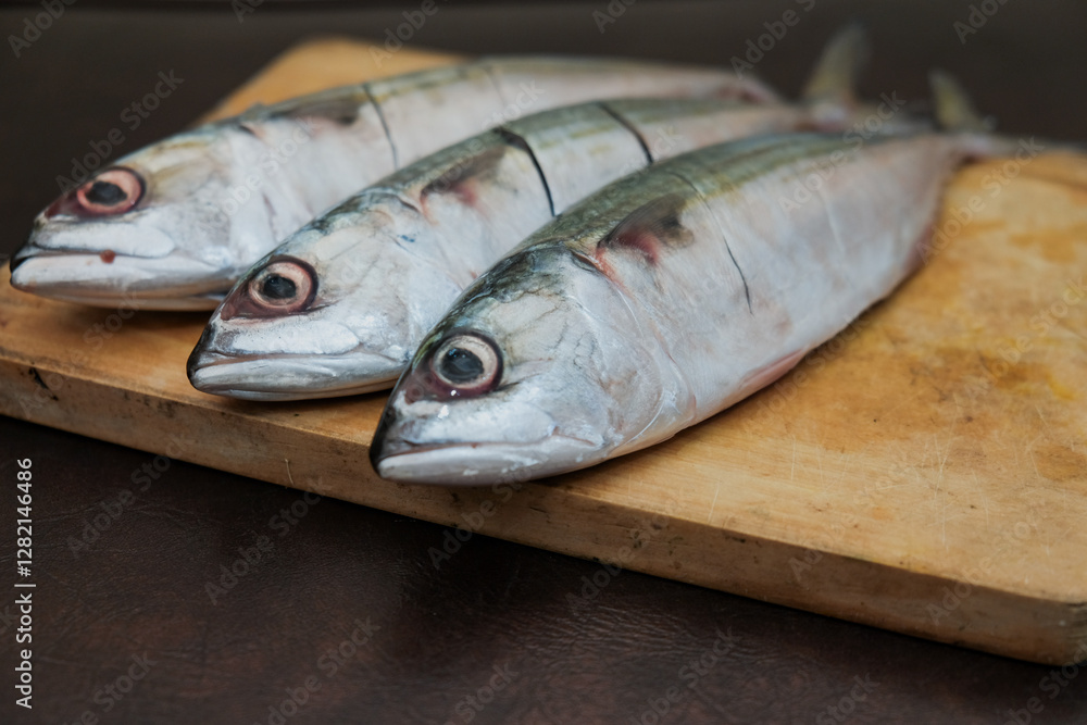 Some Fresh Mackerel Fish On Wooden Chopping Board, prepare cooking seafood Some Fresh Mackerel Fish On Wooden Chopping Board, prepare cooking seafood