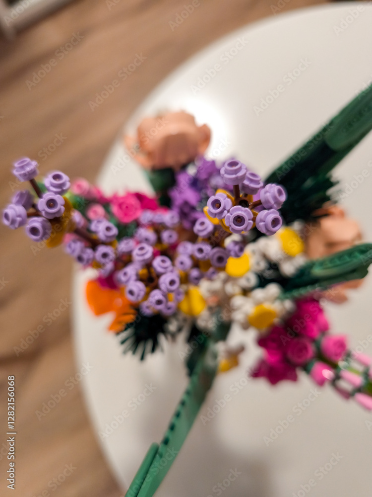 Naklejka premium Prague, Czech republic - February 20, 2025: Colorful lego flower bouquet on a white table in prague