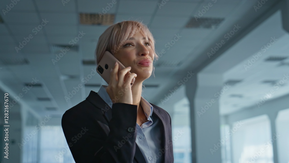 Laughing female director calling standing at modern business center hall closeup Laughing female director calling standing at modern business center hall closeup