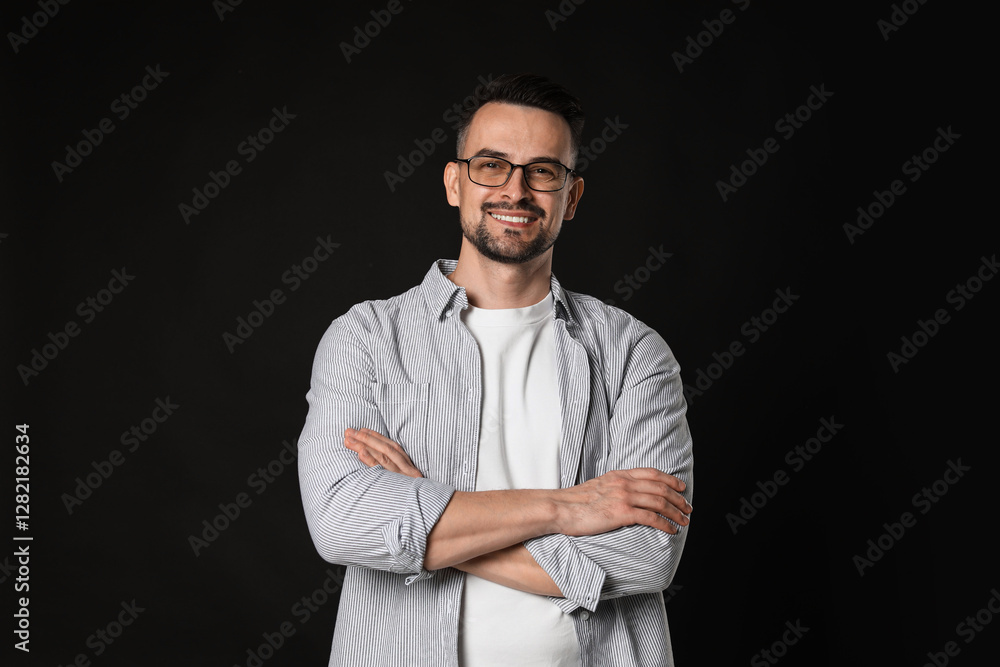 Fototapeta premium Portrait of handsome middle aged man on black background