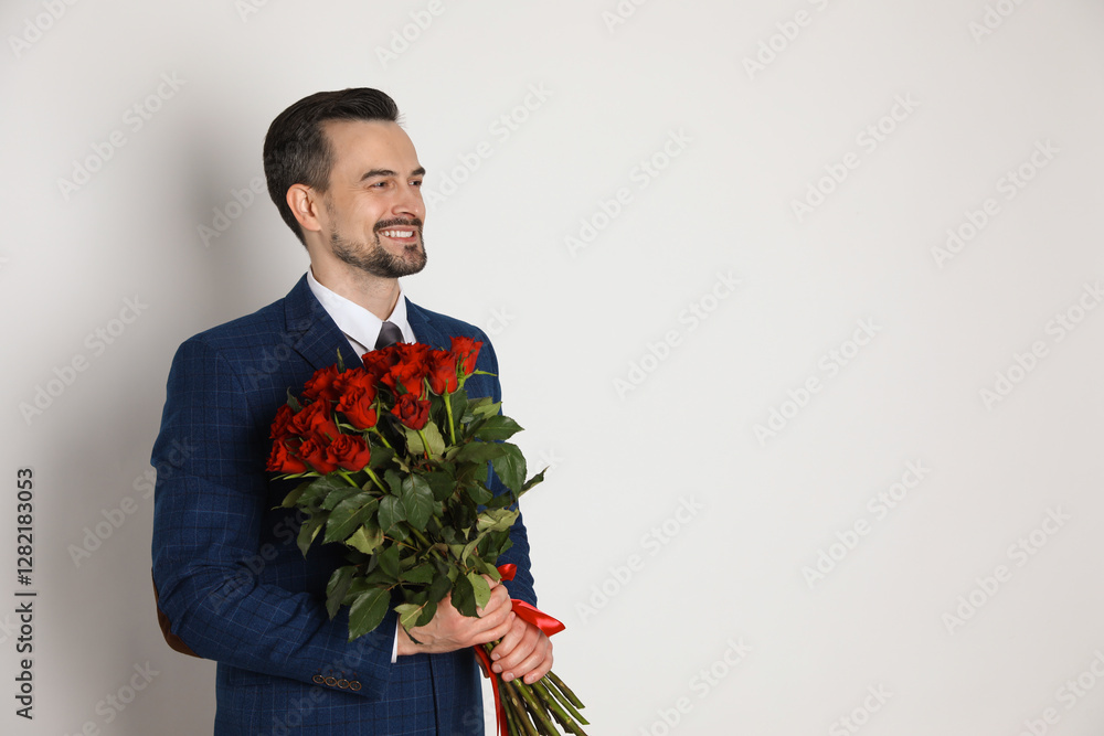 Happy Valentine's Day. Handsome man with bouquet of roses on white background. Space for text Happy Valentine's Day. Handsome man with bouquet of roses on white background. Space for text