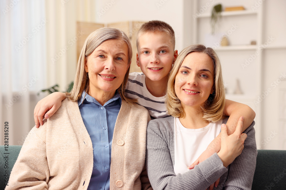 Family portrait of smiling woman, her mother and son at home Family portrait of smiling woman, her mother and son at home