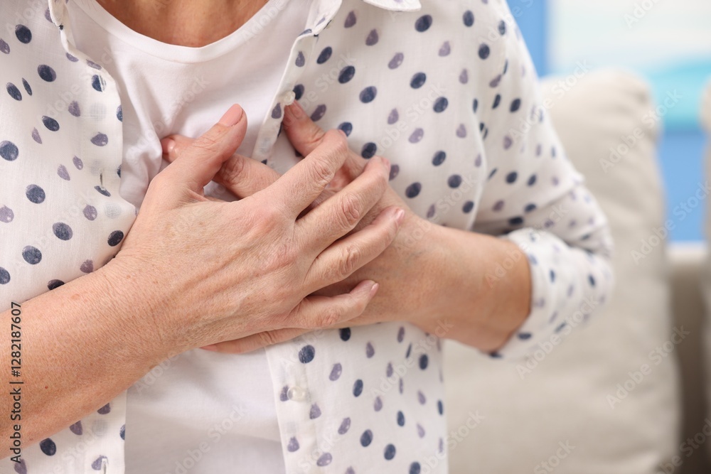 Heart attack. Senior woman suffering from pain in chest indoors, closeup Heart attack. Senior woman suffering from pain in chest indoors, closeup