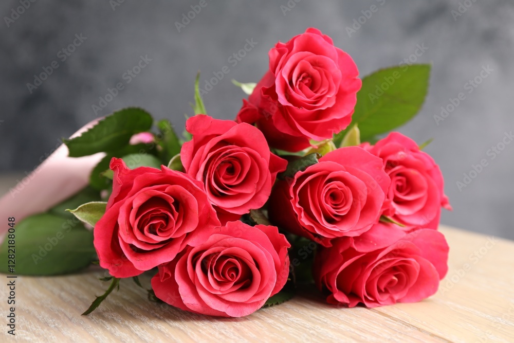 Beautiful red roses on wooden table, closeup Beautiful red roses on wooden table, closeup