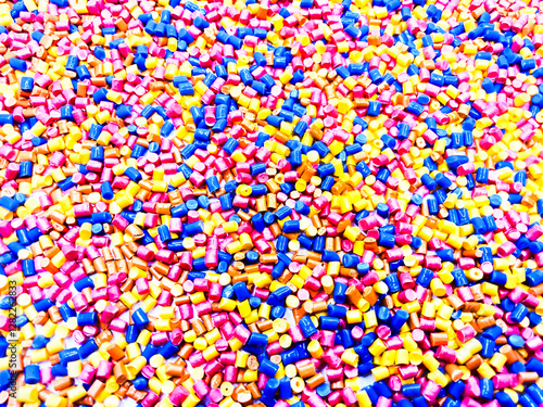 Colorful masterbatch granule, mix color polypropylene polymer granules, cold cutting type granule texture, isolated on white background, for industrial plastic company profile product catalog design	