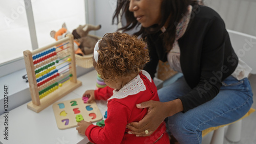 Schilderij op canvas Mother and daughter playing educational games indoors in a cozy, loving home with toys and a puzzle, embodying family warmth and nurturing environment
