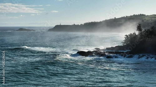 Video of large waves past Kalihiwai beach to Kilauea Lighthouse on stormy morning on the coast of Kauai