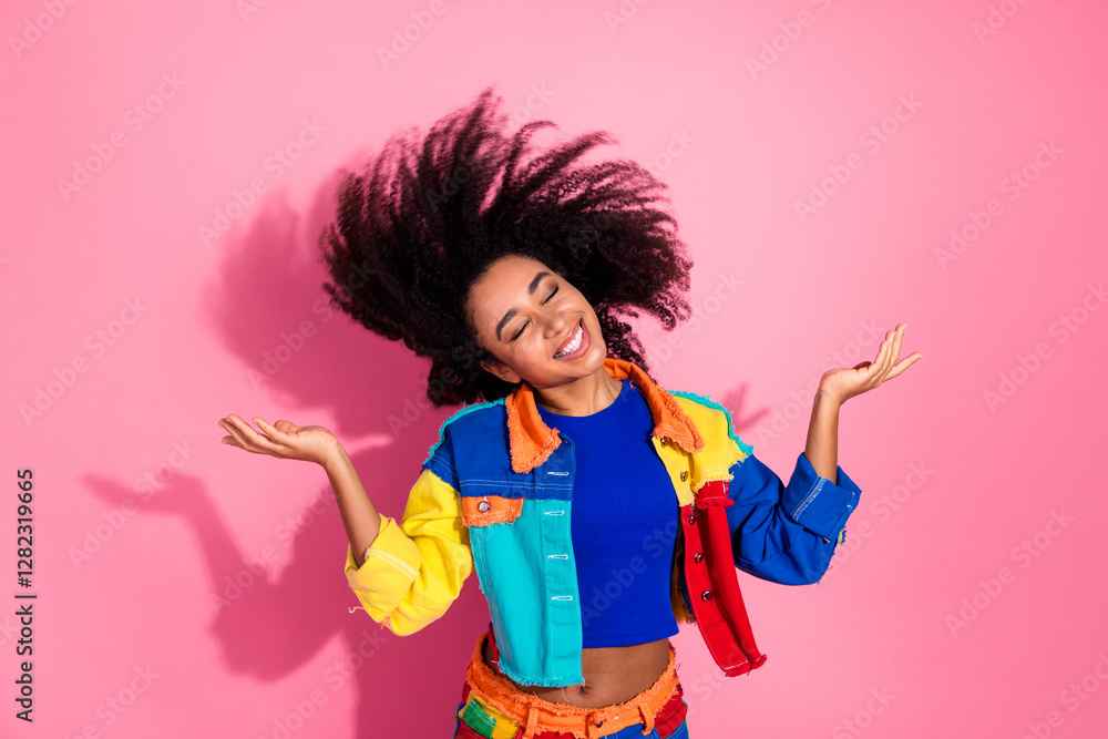 Joyful young woman with colorful style gesturing playfully against vibrant pink background Joyful young woman with colorful style gesturing playfully against vibrant pink background
