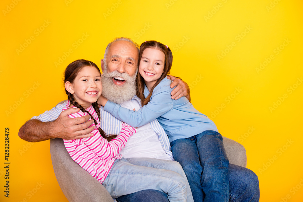 Happy grandfather enjoying cheerful moments with his two young granddaughters against bright yellow backdrop, showing love and family bonding Happy grandfather enjoying cheerful moments with his two young granddaughters against bright yellow backdrop, showing love and family bonding