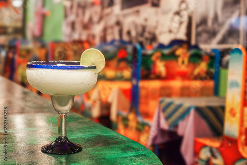 Frozen margarita cocktail sitting on bar in mexican restaurant