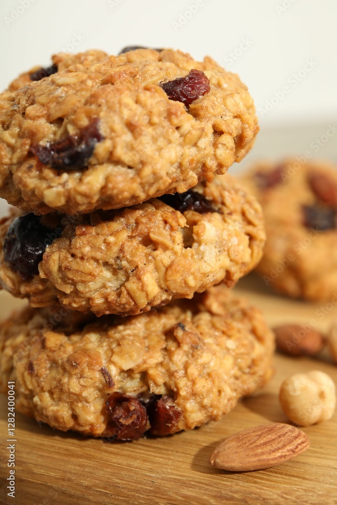Delicious oatmeal cookies with raisins and nuts on table, closeup Delicious oatmeal cookies with raisins and nuts on table, closeup