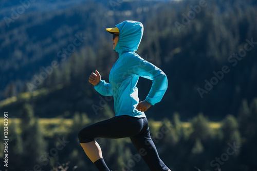 Fitness asian woman runner running at sunrise grassland photo