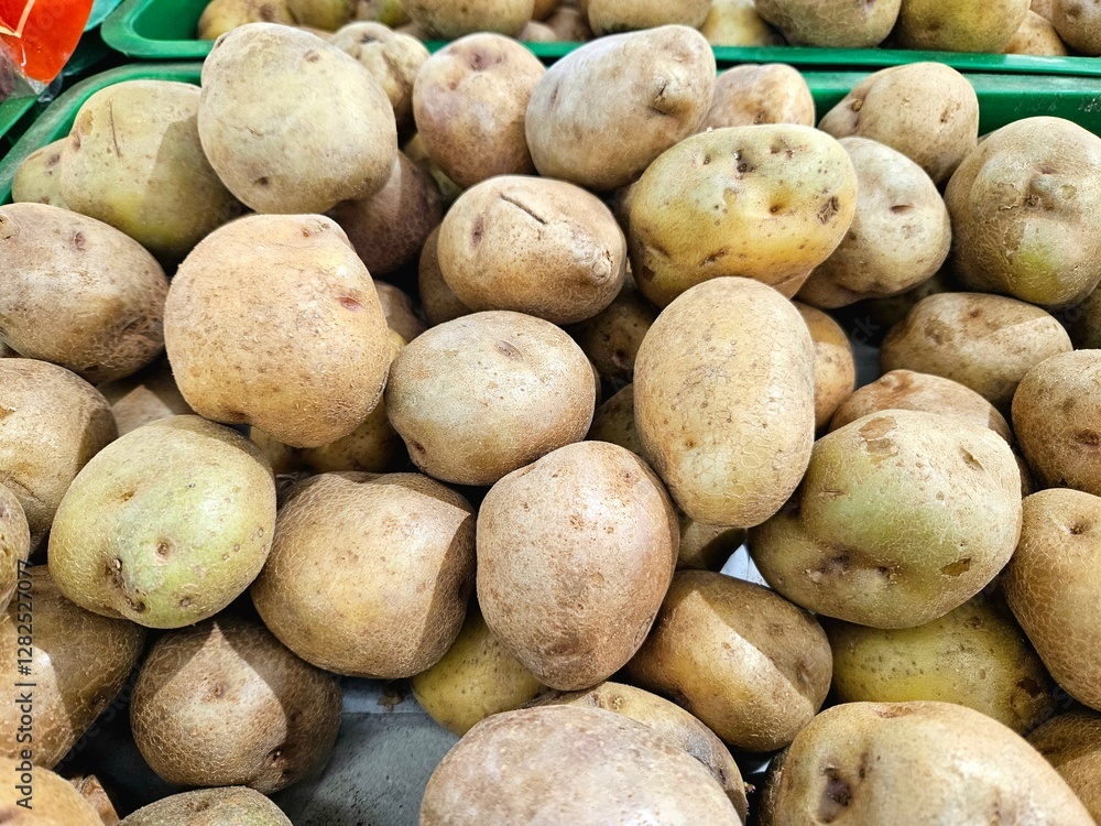 Close-up of unwashed potatoes with blemishes and rough surfaces in a grocery display Close-up of unwashed potatoes with blemishes and rough surfaces in a grocery display