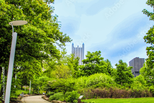 Pittsburgh skyline view framed by lush greenery in springtime park