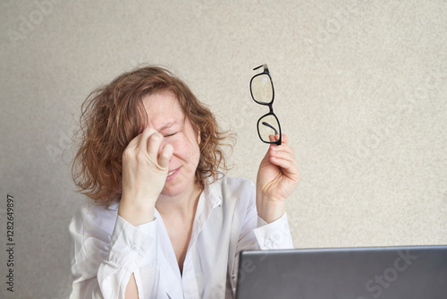 Wallpaper Mural Caucasian female adult experiencing eye strain holding glasses near laptop while rubbing eyes due to screen fatigue. Torontodigital.ca