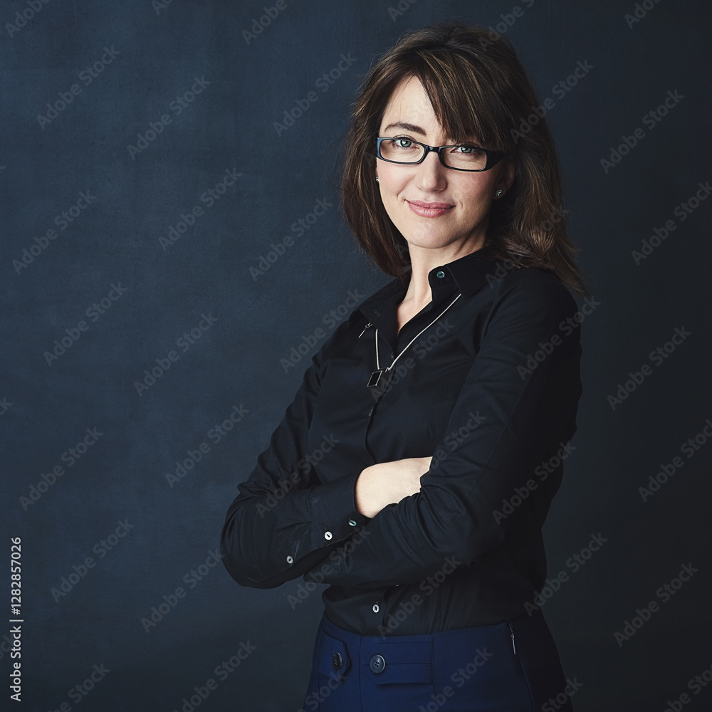 Portrait, confidence and business woman in studio, compliance officer or policy advisor. Glasses, entrepreneur and happy person with arms folded, worker and employee on dark background in Ireland Portrait, confidence and business woman in studio, compliance officer or policy advisor. Glasses, entrepreneur and happy person with arms folded, worker and employee on dark background in Ireland