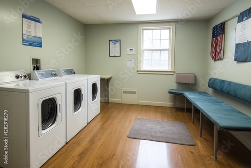 Spacious laundry area with a dedicated pet washing station, warm wood flooring, and a cozy seating corner for added convenience photo