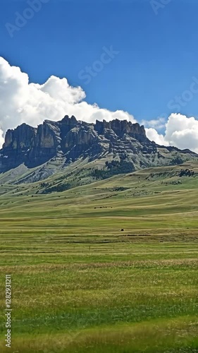 Wallpaper Mural Majestic mountain range under a blue sky with fluffy clouds in a serene valley landscape Torontodigital.ca