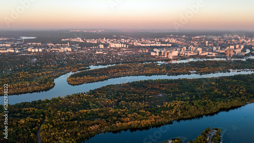 Kyiv city sunset skyline and Dnipro river aerial drone view from above, Kiev hills, pedestrian Park bridge and Dnieper river cityscape in autumn, Ukraine photo