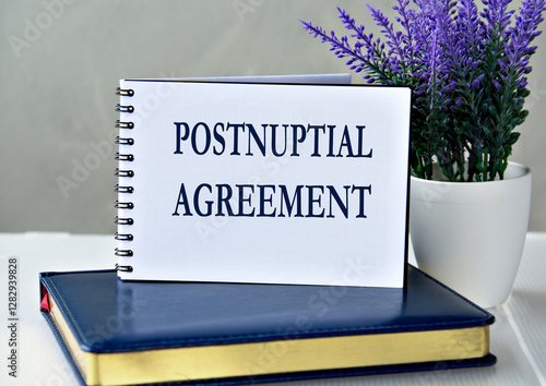 POSTNUPTIAL AGREEMENT - words in a notebook against the background of a diary and lavender