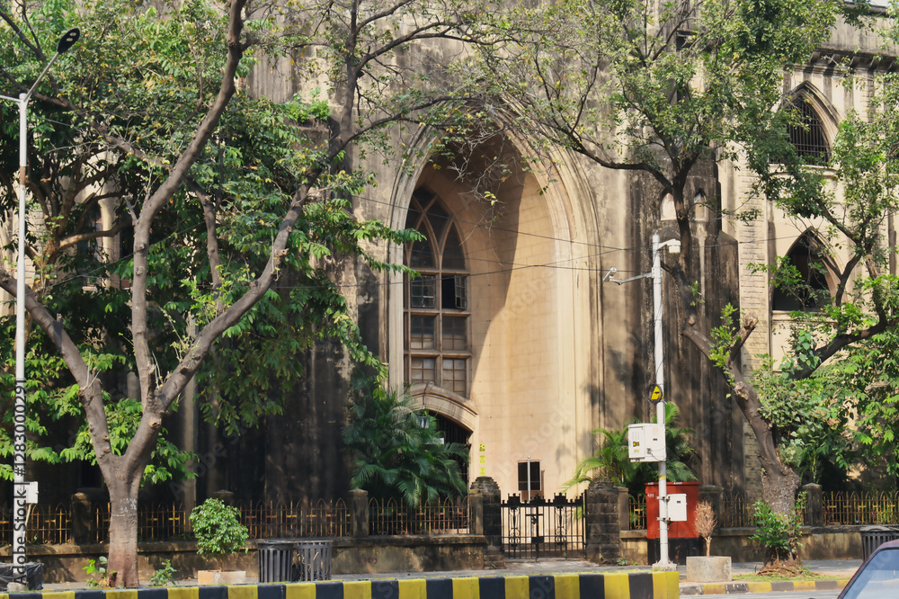 A gothic-style church stands amidst greenery in an urban setting, showcasing beautiful architecture and a serene atmosphere in the surrounding area A gothic-style church stands amidst greenery in an urban setting, showcasing beautiful architecture and a serene atmosphere in the surrounding area