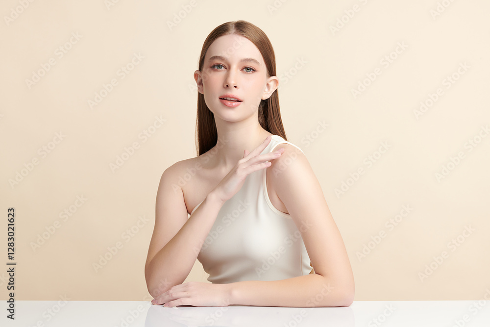 Obraz premium Beautiful young woman with clean fresh skin on beige background, Face care, Facial treatment, Cosmetology, beauty and spa, women portrait.