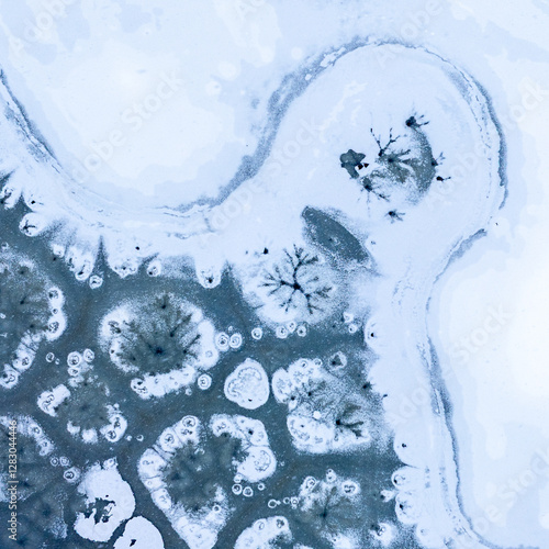 Winter abstract frozen textures. Aerial view of a frozen lake with intricate ice formations, showing unique patterns and natural beauty in a winter landscape.
