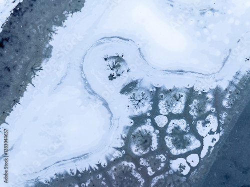 Winter abstract frozen textures. Aerial view of a frozen lake with intricate ice formations, showing unique patterns and natural beauty in a winter landscape.