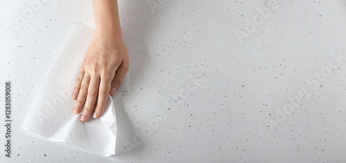 Quadro em tela Woman wiping light table with paper towel