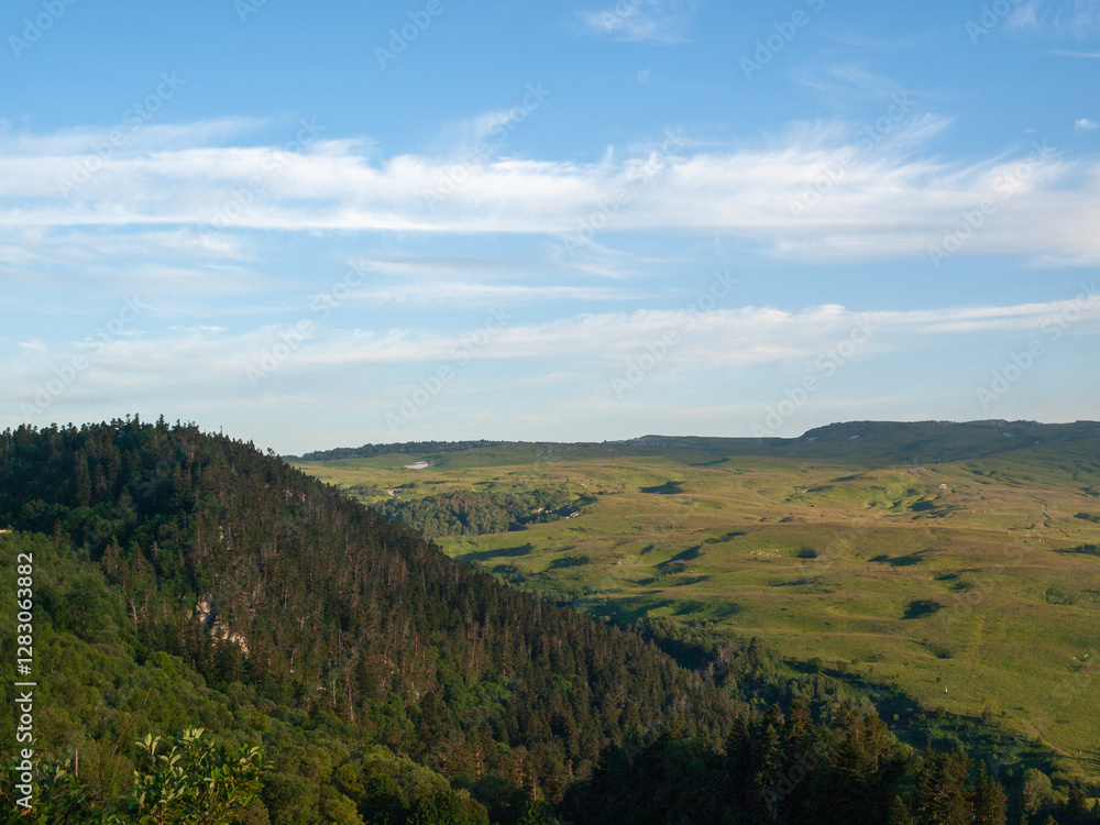 Fototapeta premium Green mountain plateau in summer under blue sky