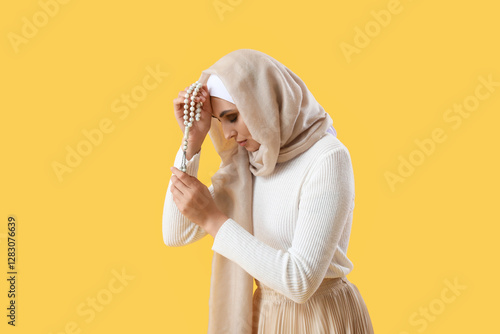 Young Muslim woman with pra...