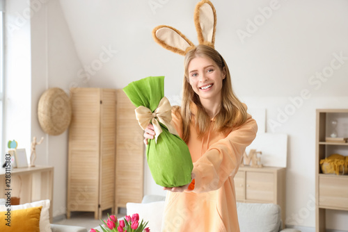 Young woman in bunny ears w...