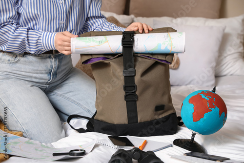 Female traveler packing bac...