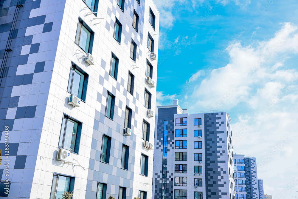 Fototapeta premium The concept of modern architecture, residential complex, apartment buildings for living. The camera moves smoothly along a multi-storey, multi-apartment residential complex of modern architecture in
