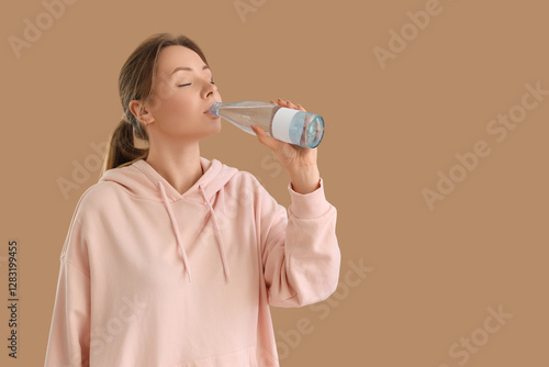 Young woman drinking water ...