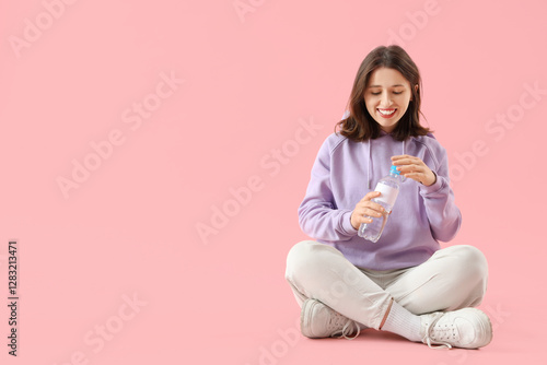 Young woman with bottle of ...