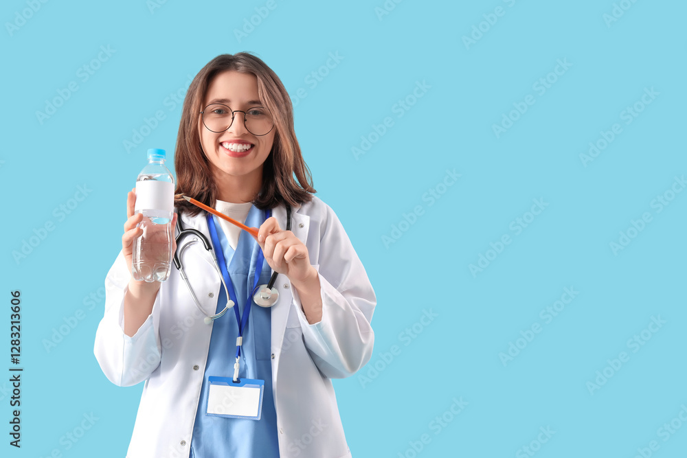 Female doctor with bottle of water on blue background Female doctor with bottle of water on blue background