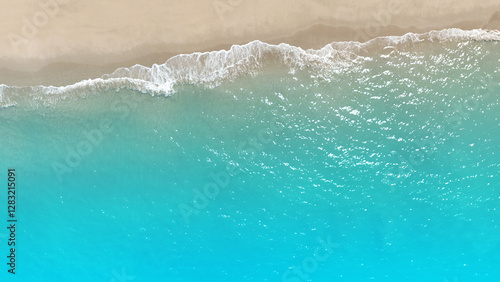 Fototapeta Naklejka Na Ścianę i Meble -  Tropical Beach with the soft wave water of the sea on the sandy beach background as texture with splashes