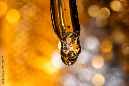 Wallpaper Mural Bottle pipette dropper close up and Liquid yellow-orange retinol or vitamin c gel or serum on a dark background. Torontodigital.ca