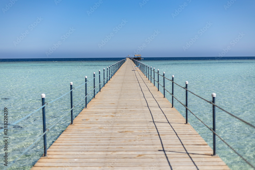 Long wooden pier stretching into the crystal-clear sea of marsa alam, egypt Long wooden pier stretching into the crystal-clear sea of marsa alam, egypt