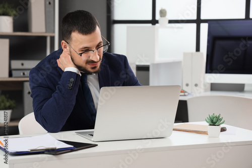 Young businessman suffering...